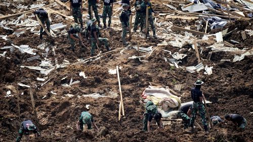 Rescuers search for victims of an earthquake-triggered landslide in Cianjur, West Java, Indonesia, Wednesday, Nov. 23, 2022. 