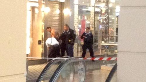 Police detain a man reportedly inside the Westfield Parramatta shortly after a fatal stabbing. (Twitter)