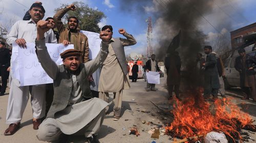 Protesters burn an effigy of Indian Prime Minister Narendra Modi in Peshawar, Pakistan.