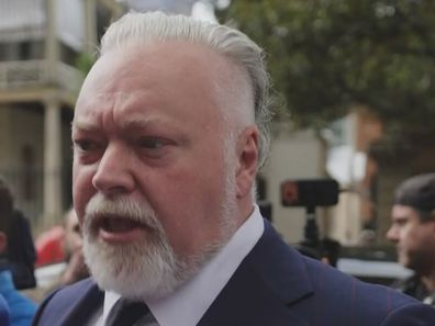 Kyle Sandilands was mobbed by reporters outside of court.