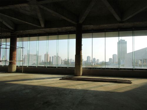 Inside the hotel on the ground floor. The skyline of Pyongyang can be seen through the glass windows.