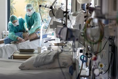 Medical personnel at work in the intensive care unit of the hospital Pourtales site "Hospital Pourtales" during the coronavirus disease (COVID-19) outbreak in Neuchatel, Switzerland, Monday, March 23, 2020. (Jean-Christophe Bott/Keystone via AP)