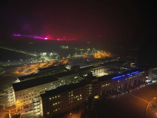 Fire burns on a hill near a hospital in Alexandroupolis, in the northeastern Evros region, Greece, early Tuesday, Aug. 22, 2023.  