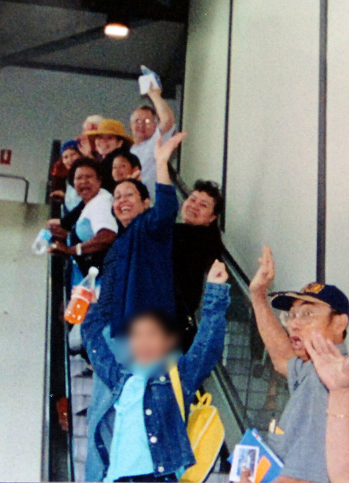 The last photo taken of the Brisbane mother (waving, centre, blue top) as she leaves for the cruise holiday. (AAP)