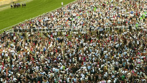 A huge crowd gathers for the races, drawn from the UK's middle and upper classes. (Getty)