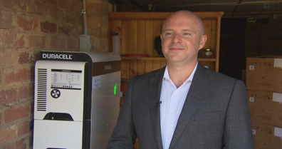 Chris Williams, CEO and Founder of Natural Solar - Australia's largest batter installer - stands in front of  Australia's first Duracell battery.