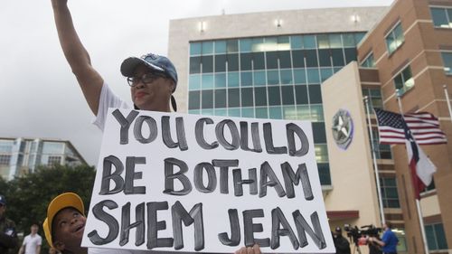 Dr. Pamela Grayson and Solomon Grayson, 6, at a Mothers Against Police Brutality candlelight vigil for Botham Jean at the Jack Evans Police Headquarters