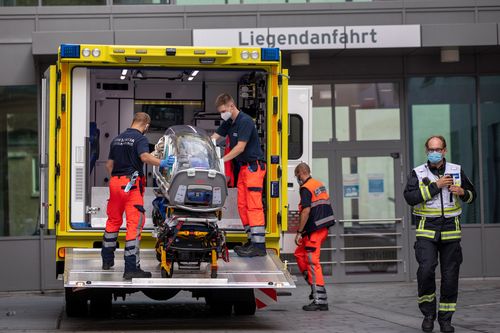 German army emergency personnel load a portable isolation unit into their ambulance that was used to transport Russian opposition figure Alexei Navalny at Charite hospital.