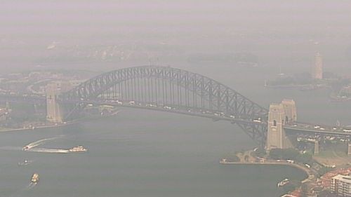Sydney's iconic Harbour Bridge is still blanketed by a thick smoke haze as several fires burn across NSW.