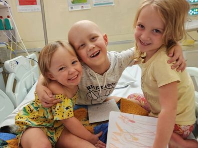 Ollie's sisters love to keep him company when in hospital. 