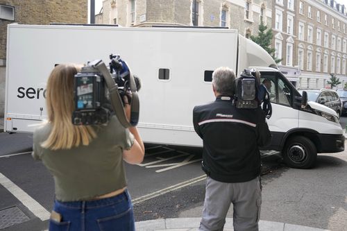 Journalists film a prison van moving into Westminster Magistrates Court in London, Wednesday, Aug. 17, 2022. 