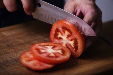 slicing tomato with knife