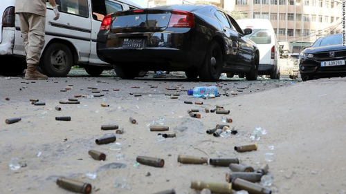Bullet shells are seen on the ground. 
