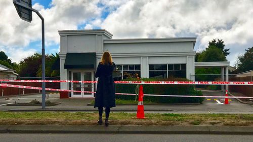 'There were times before a live cross or after when I broke down in tears'. Sophie Walsh stands behind police tape in Christchurch.