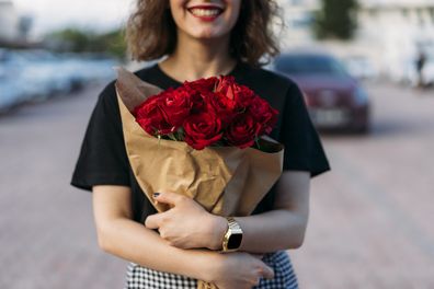 Woman holding red roses
