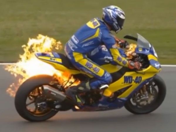 Racer's lucky escape after Superbike bursts into flames