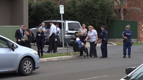 Police speak to an elderly woman who was victim to a car-jacking in Sydney's south yesterday.