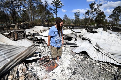 Liam McKenzie inspects the remains of his house which was destroyed by bushfires in Rappville, NSW, Thursday, October 10, 2019. Several properties were lost when an out-of-control bushfire swept through the northern NSW village. (AAP Image/Dan Peled) NO ARCHIVING