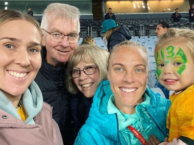 Tameka Yallop of the Matildas (second right) with her family, including daughter Harley.
