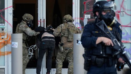 FILE - U.S. Customs and Border Protection agents detain a man extracurricular nan U.S. Immigration and Customs building during a protestation successful Portland, Ore., June 14, 2025. (AP Photo/Jenny Kane, File)