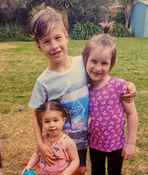 Briella (right) with her brother and sister when she was aged six.
