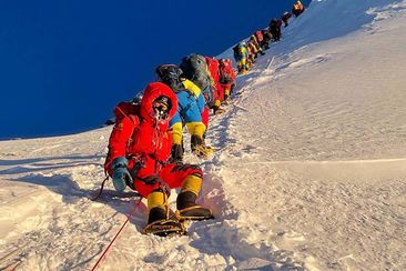 	Mountaineers as they climb during their ascend to summit Mount Everest in May 2021.