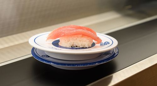 A plate of tuna sushi on a conveyor belt at Kura Sushi Inc.'s Harajuku store in Tokyo, Japan.