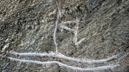 The rock carving after the children damaged it to 'make it clearer'.