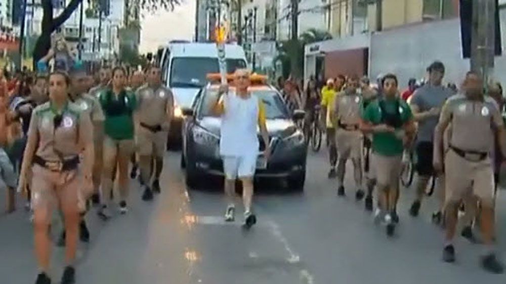 Brazil icon takes a tumble with Olympic torch