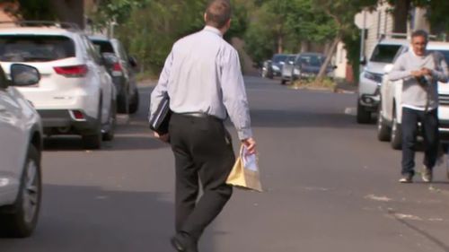 Detectives appeared to take evidence from the apartment after scouring the scene this morning. (9NEWS)