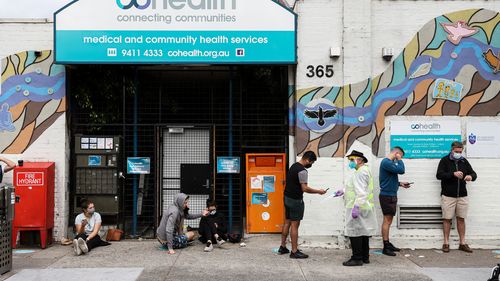 People queue outside a Covid-19 testing site in Collingwood  in Melbourne.