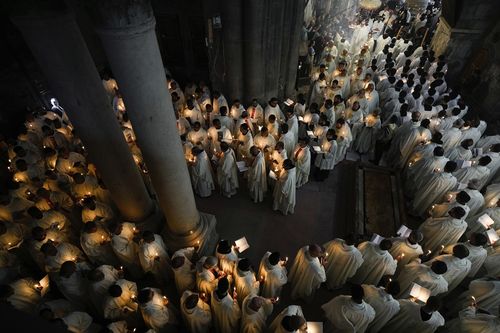 Catholic clergy hold candles as they walk during the Washing of the Feet procession at the Church of the Holy Sepulcher, where many Christians believe Jesus was crucified, buried, and rose from the dead, in the Old City of Jerusalem, Thursday, March 28, 2024. 