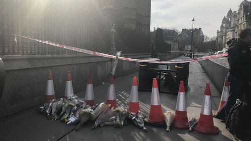 Londoners have started leaving flowers at the scene of the attack. (Gabrielle Adams/9NEWS)
