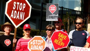 Protesters are seen during a Stop Adani Protest at Lady Martin's Beach, Point Piper in May 2018. Picture: AAP