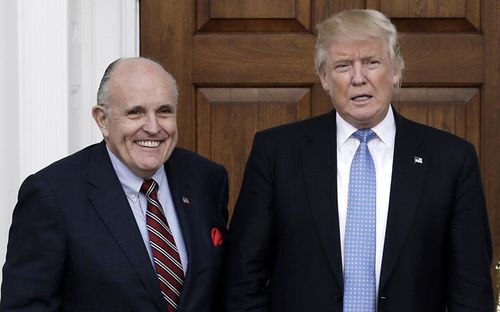 Former New York City Mayor Rudy Giuliani poses with US President Donald J. Trump at the clubhouse of Trump International Golf Club, in Bedminster Township, New Jersey