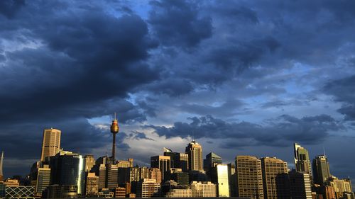 Clouds gather over the Sydney CBD skyline. Workers are expected to return to the office in greater numbers over the coming weeks.