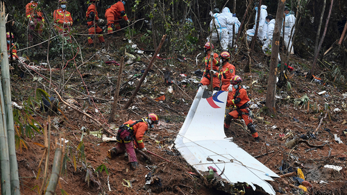 Search and rescue workers search through debris at the China Eastern flight crash site in Tengxian County in southern China's Guangxi Zhuang Autonomous Region on March 24, 2022.