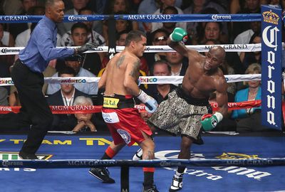 Maidana used his left forearm to push back Mayweather  in the 10th round.