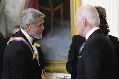 President Joe Biden shakes hands with actor, director and producer George Clooney during the Kennedy Center honorees reception at the White House in Washington, Dec. 4, 2022. 