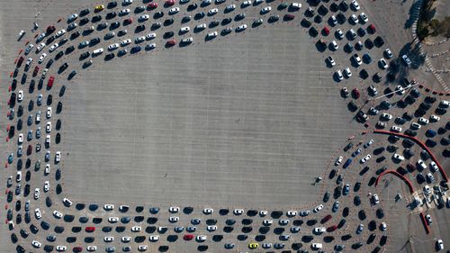 Motorists line up to take a coronavirus test in a parking lot at Dodger Stadium