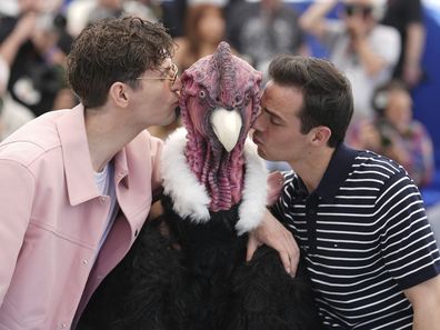 Raphael Quenard and Hugo David pose with a person dressed in bird costume at a photocall for the film Die, My Love at the 78th international film festival, Cannes, May 18, 2025.