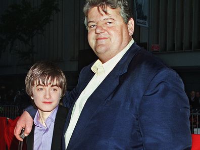 Daniel Radcliffe, left, who plays Harry Potter in the new movie "Harry Potter and the Sorcerer's Stone," and Robbie Coltrane, who plays Hagrid in the film, arrive for the film's New York premiere on Nov. 11, 2001. 