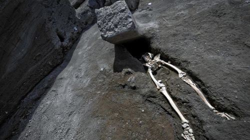 The discovery of this skeleton near Pompeii in Italy suggests a man attempting to flee the 79AD eruption of Mount Vesuvius died in a strange fashion. Picture: AAP.