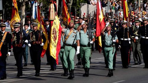 Several Spanish legionnaire take part in the army parade to mark Spain's National Day in downtown Madrid. (AAP)