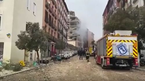 In this image made from video provided by Emergencias Madrid, firefighters attend the scene after an explosion in Madrid, Wednesday, Jan. 20, 2021.