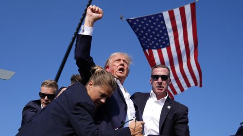 FILE - Republican presidential candidate former President Donald Trump is surrounded by U.S. Secret Service agents after an assassination attempt at a campaign rally in Butler, Pa., July 13, 2024. (AP Photo/Evan Vucci, File)
