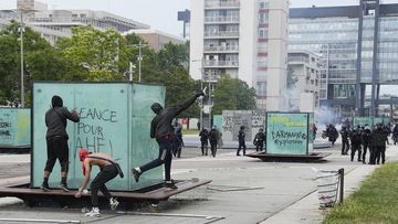 Youth throws a bottle to police forces during riots Thursday, June 29, 2023 in Nanterre, outside Paris. 