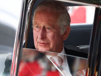 King Charles pictured in 2022, looking out of a car window.