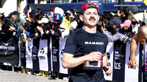 Lukas Schindler from Switzerland crossing the finish line at the Sydney marathon.