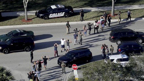 Students are led from Marjory Stoneman Douglas High School after the shooting. (AP/AAP)
